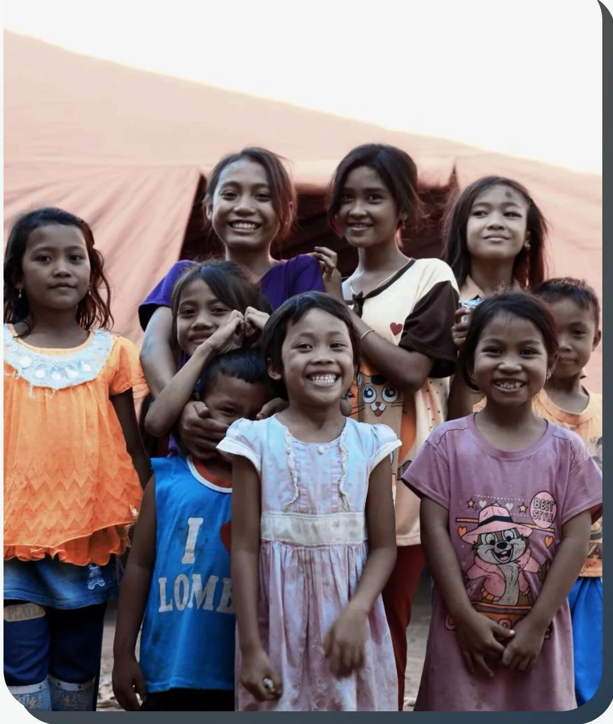 Children from a partner community gathered outdoors during a program activity in Indonesia.